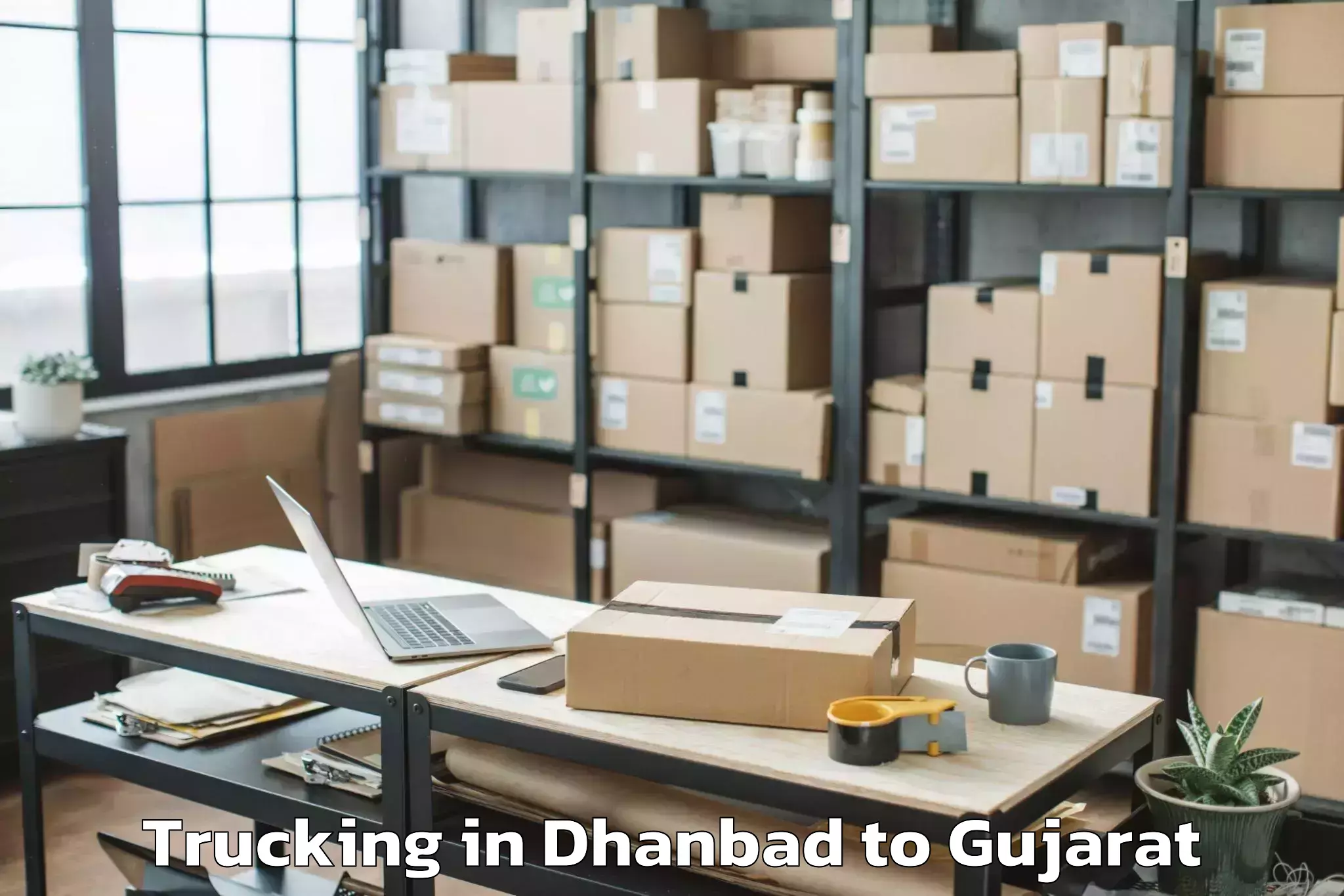 Leading Dhanbad to Tilakvada Trucking Provider